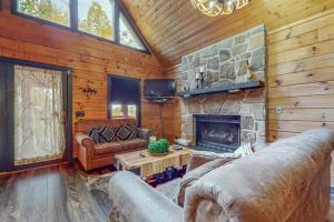 a living room with a couch and a fireplace at The Sweet Escape at Sky Harbor in Sevierville