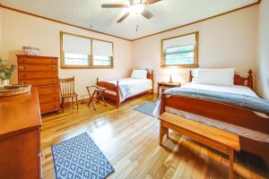 a bedroom with two beds and a dresser at Mayville Vacation Rental - Walk to Chautauqua Lake in Mayville
