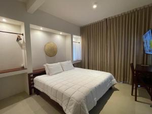 Postel nebo postele na pokoji v ubytování Cuatro Lunas Hotel Boutique
