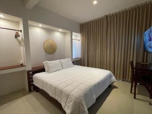 Postel nebo postele na pokoji v ubytování Cuatro Lunas Hotel Boutique