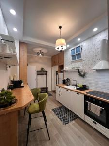 a kitchen with white cabinets and a table and chairs at MOM Boutique Rooms in Budapest