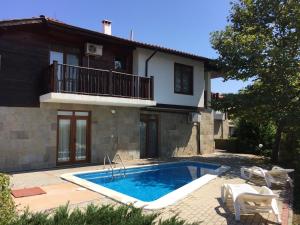 a swimming pool in front of a house at HillTop Villa in Burgas