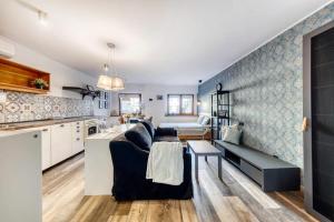 Una sala de estar con un sofá y una cocina. en Apartament Gdańska 13, en Bydgoszcz 5 fotos más