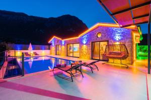 a villa with a swimming pool at night at Villa estrella in Kaş