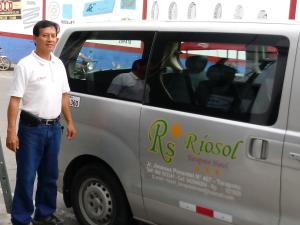 a man standing in front of a van at Riosol Hotel Tarapoto in Tarapoto