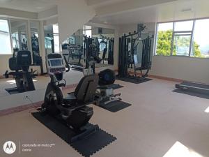 a gym with treadmills and ellipticals in a room at Riosol Hotel Tarapoto in Tarapoto