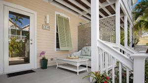 a porch with a chair and a table on a house at Sea Breeze Villa in Key West
