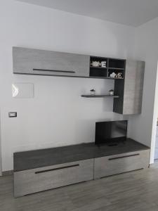a living room with a tv on a wall at Deluxe apartment Fiumicino near airport, free parking in Isola Sacra