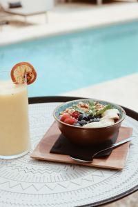 a bowl of food on a table next to a candle at Pure House Ibiza in Ibiza Town
