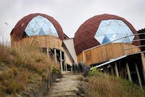a building with two domes on top of a hill at Villa del lago Glamping in Tota