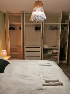 a bedroom with a bed with two towels on it at Flat Colina Magurii Bacau in Măgura