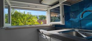 a kitchen with a sink and a window at Le casette in Monopoli