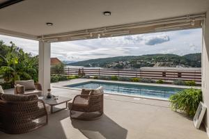 a house with a swimming pool and a patio at Villa Remi in Sumartin