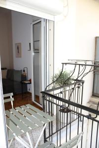 a staircase in a living room with a couch at Parthenon retreat in Athens