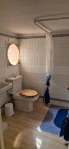 a bathroom with a toilet and a window at Casa Fina in Torrevieja +19 photos