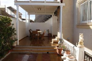 a balcony with a table and chairs in a building at Casa Fina in Torrevieja