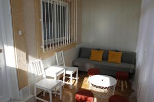 a living room with a couch and chairs and a table at Casa Fina in Torrevieja