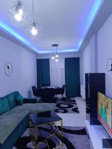 a living room with a couch and a television at Vision Apartment "self check in" Thessaloniki in Thessaloniki