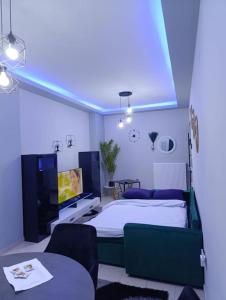 a bedroom with a bed and a tv in it at Vision Apartment "self check in" Thessaloniki in Thessaloniki