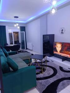 a living room with a couch and a flat screen tv at Vision Apartment "self check in" Thessaloniki in Thessaloniki +48 photos