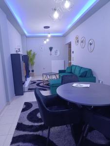 a living room with a table and a couch at Vision Apartment "self check in" Thessaloniki in Thessaloniki