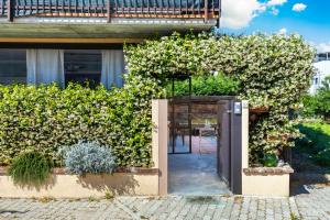 an open door into a garden with flowers at L'essenziale - Experience in Alba Free Park & WiFi in Alba