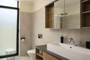 a bathroom with a sink and a toilet at Villa Ohana in Estreito da Calheta