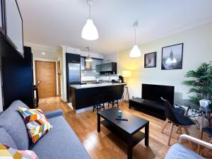 a living room with a couch and a table at Apartamento con garaje, céntrico y luminoso in Pontevedra +22 photos