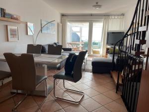 a living room with a couch and a table and chairs at Haus Sterngucker in Breege