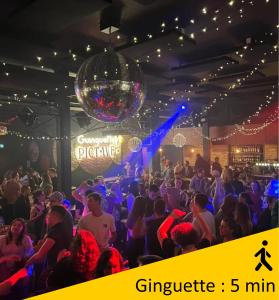 a crowd of people dancing in a room with a disco ball at Le Girouard - City Center - Private Parking - WIFI, NETFLIX in Poitiers +13 photos