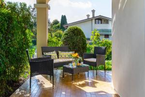 a patio with a table and chairs on a patio at Villa Magnolia in Porcia