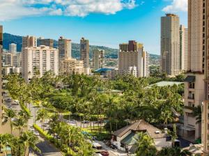 a city skyline with palm trees and buildings at 1519 Ilikai Collection 9 Beachfront Resort recently upgraded in Honolulu