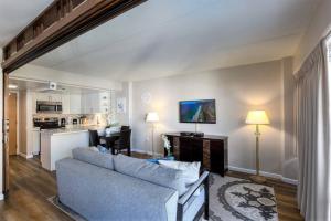 a living room with a couch and a kitchen at 1519 Ilikai Collection 9 Beachfront Resort recently upgraded in Honolulu