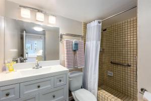 a bathroom with a toilet and a sink and a shower at 1519 Ilikai Collection 9 Beachfront Resort recently upgraded in Honolulu +8 photos