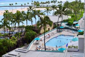 an aerial view of a resort swimming pool and a beach at 1519 Ilikai Collection 9 Beachfront Resort recently upgraded in Honolulu