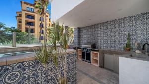 a kitchen with a sink and a counter top at One Medano 8B in Cabo San Lucas