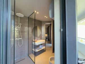 a bathroom with a shower and a sink and a mirror at Zins Luxury Rooms in Durrës +116 photos