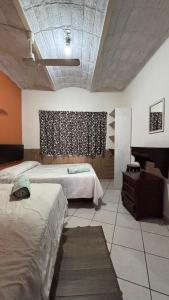Una cama o camas en una habitación de Bungalows Flamingos