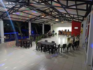 a dining hall with tables and chairs in a building at Quinta de San Pedro in Villavicencio