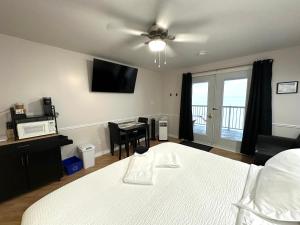 a bedroom with a bed and a table and a television at Haileybury Lakehouse in Haileybury