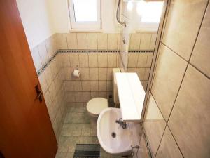 a small bathroom with a toilet and a sink at Apartments Boro in Dugi Rat