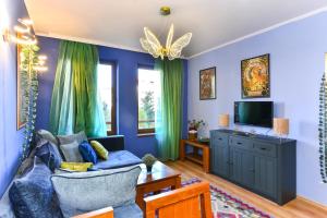 a living room with blue walls and a blue couch at Cedar Lodge III One BDRM Flat B2 in Bansko