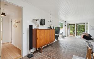 an open living room with a tv and a desk at Three-Bedroom Holiday Home Thyholm With A Fireplace 06 in Sønder Ydby