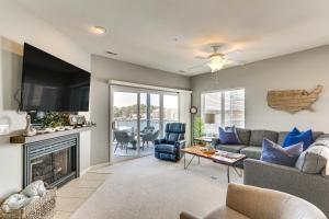 a living room with a couch and a fireplace at Sunshine Shack Lake Ozark Condo Pool, Lake View in Lake Ozark