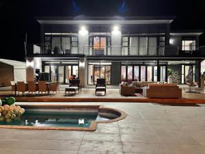 a large house with a pool in front of it at Champagne Manor in Mountain Herberg Hostel