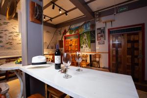 萨兰托Hostal El Quinde的配有2杯酒和1瓶葡萄酒的柜台