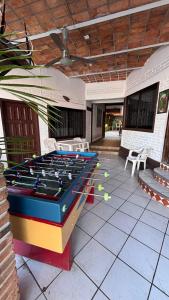 a room with a pool table and ping pong balls at Bungalows Flamingos in Rincon de Guayabitos