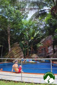 a group of people in a pool at a water park at Finca Ecoturistica Piedra Alta in Puerto Arturo