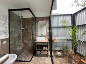 a bathroom with a shower and a sink at Las Chapitas in Santa Clara del Mar