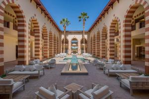 a courtyard with chairs and a fountain in a building at Marina Resort Port Ghalib, a member of Radisson Individuals in Port Ghalib